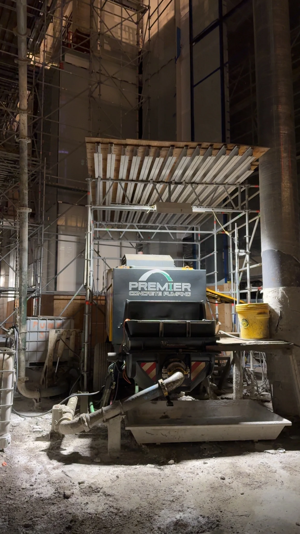 Boom pump truck extending over a commercial construction site in Ontario