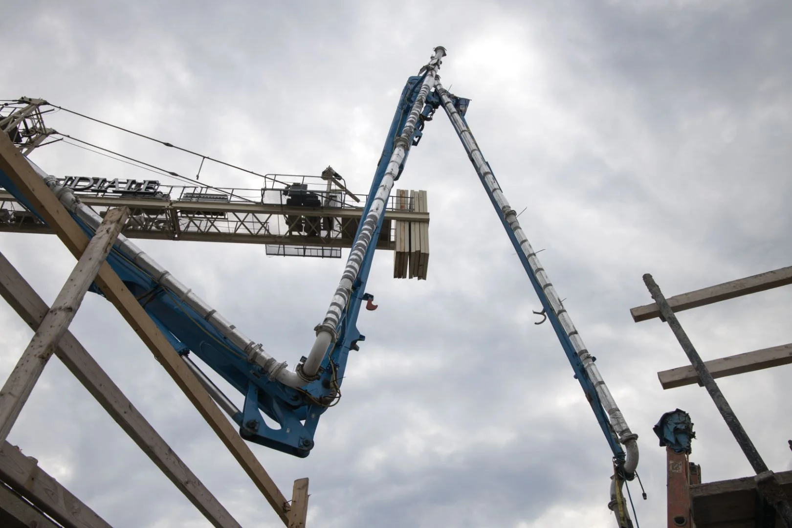 Placing boom mounted on a high-rise construction tower placing concrete on an upper floor